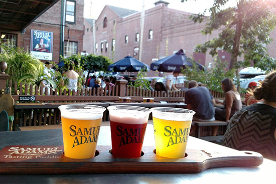 Patrons sit on the patio tasting beers at Sam Adams Boston Brewery