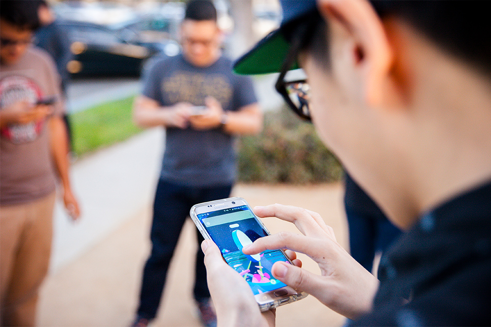 A group of men and women playing Pokemon Go