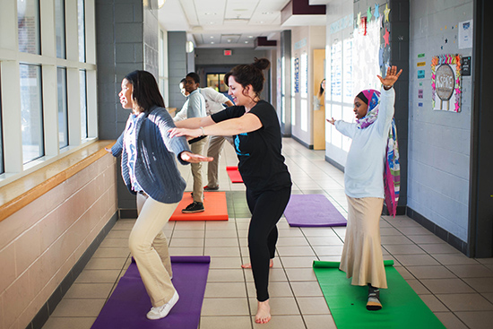 Susan Lovett (SSW’98) teaches a yoga class to students