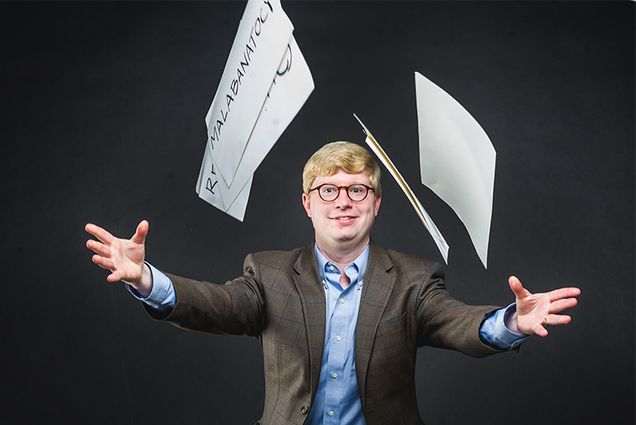 Tyler Perrachione, Director of Boston University Sargent College Communication Neuroscience Research Laboratory, holds a card showing a word used in the nonword repetition tests studying language disorders and phonological working memory in the dyslexic brain