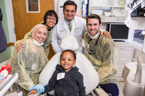 Patient Levi McBride with (from left) Yasmin Alayyoubi, Dolrudee Jumlongras, Athanasios Zavras, and Stephen Prieve