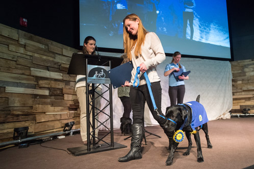 Miltner walks Gem across the stage during the Canine Companions graduation ceremony