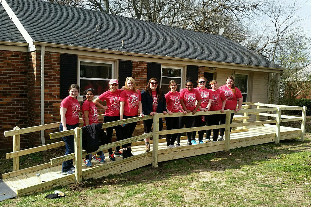 group of BU students on wheelchair ramp they've built