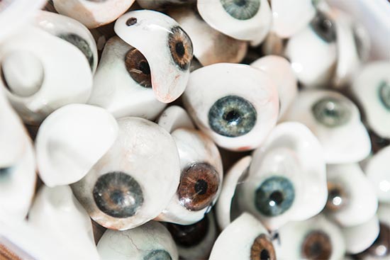 A pile of prosthetic eyes hand sculpted by Kaylee Dougherty of Boston Ocular Prosthetics, Inc.