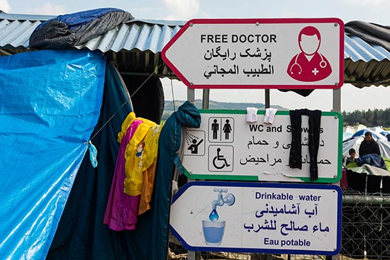 Free Doctor and Drinkable Water signs in a Syrian Refugee Camp in Eidomeni, Greece