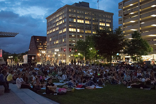crowd of people on greenway watching movie