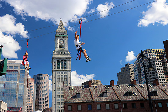 Zipline riders above the Rose Kennedy Greenway