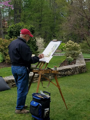 Man painting on art canvas in the outdoors