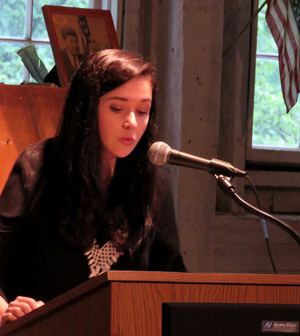 Caitlyn Doyle reading at podium