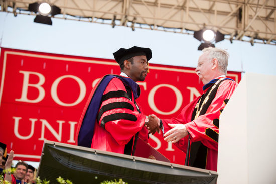 Boston University President Robert Brown presents an honorary degree to former NAACP president Cornell William Brooks during the 2015 Boston University Commencement