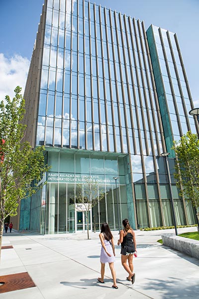 Two students walk by the entrance to the Kilachand Center for Integrated Life Sciences and Engineering science building at Boston University