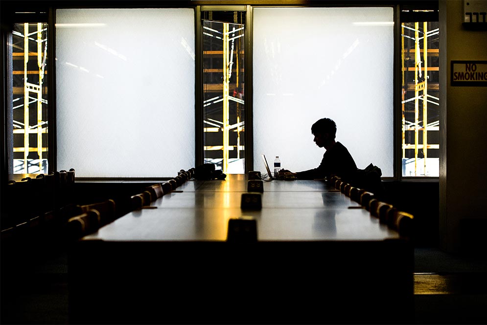 Student studies lone in dark library