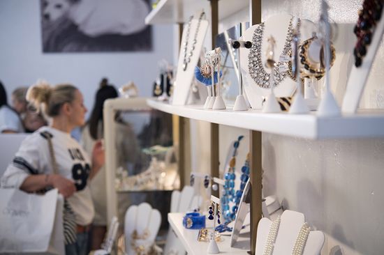 A shopper browses jewelry in Covet consignment shop, West Broadway St, Boston