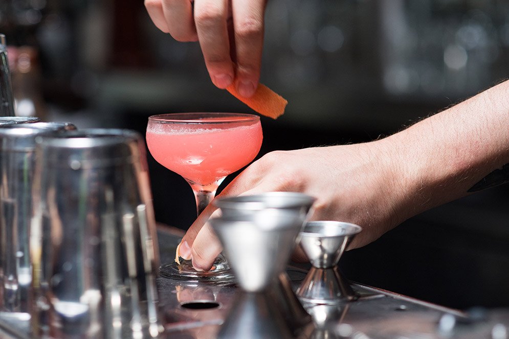 A bartender makes a cocktail at Deep Ellum in Allston, MA