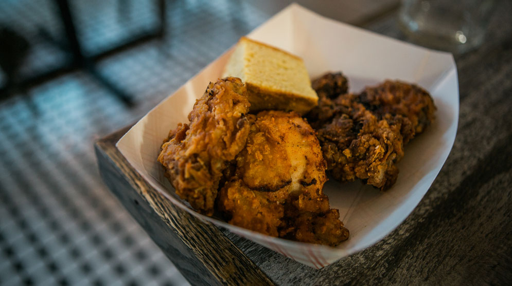 At Kitchen Sink, every Monday is fried chicken night, featuring deep-fried buttermilk-soaked chicken with pickled vegetables, cornbread, and slaw.