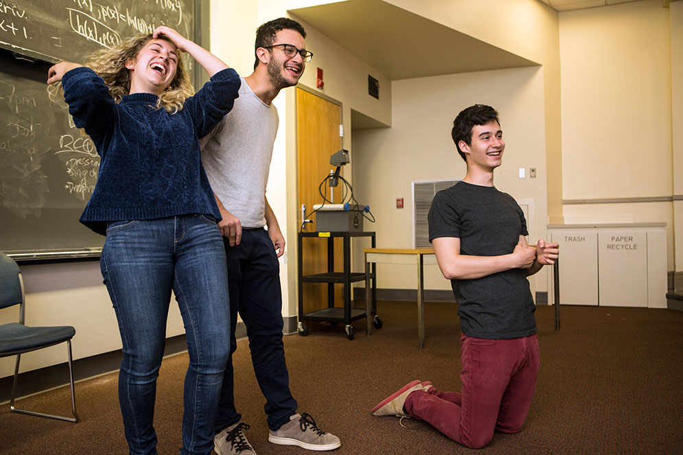 Sarah Sosland (COM’18) (from left), Adam DeAngelo (COM’19), and Ben Sisson (CAS’19) during an improv practice exercise called Sing Ding. Photo by Jake Belcher