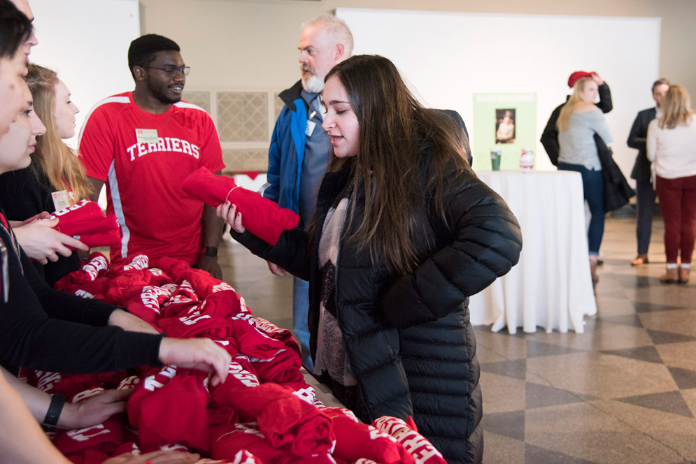 Alyssa Sachs (Wheelock '20) picks up her complimentary Terrier shirt during the Wheelock Visit Day faculty meet and greet.