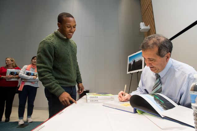 White House photographer Pete Souza (COM'76) signs copies of his book, Obama: An Intimate Portrait.