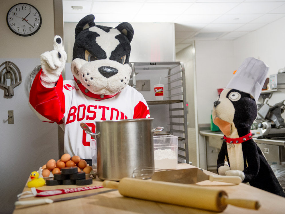 BU mascot Rhett the Terrier bakes sweets with Rhett puppet lookalike in 2015.