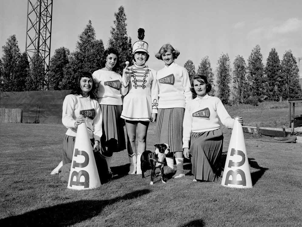 Cheerleaders and a drum majorette keep the BU mascot company during a game at Nickerson Field in 1954.