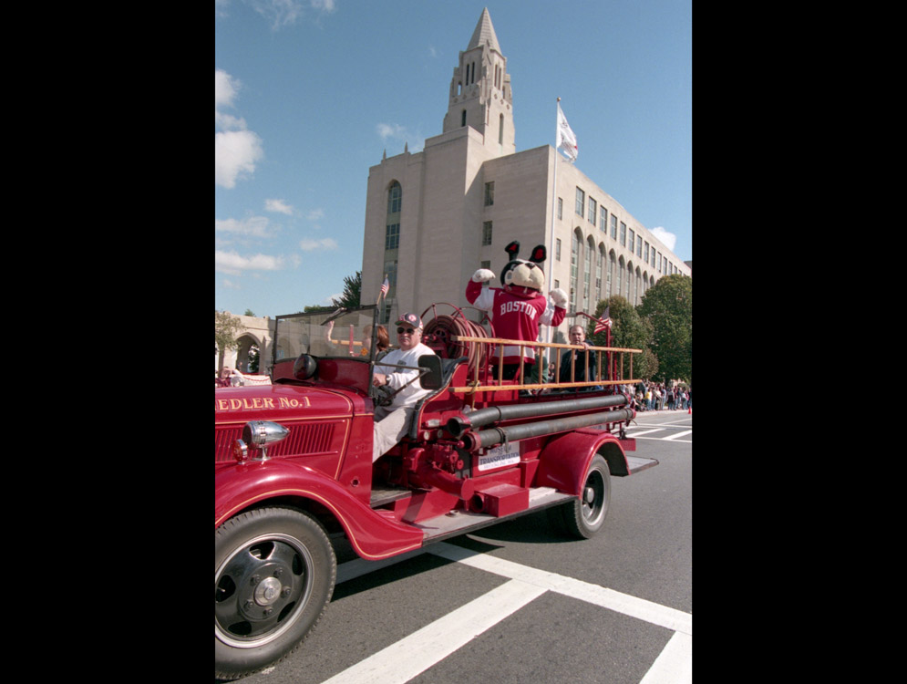 The BU mascot rides on a firetruck during the 1999 homecoming parade on Commonwealth Ave.