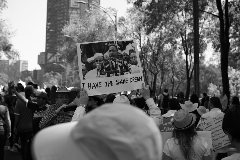 A protester holds a poster with a picture of Martin Luther King. The sign says, "I have the same dream."