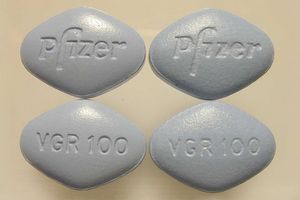 Real and counterfeit Viagra pills side by side. Real Viagra is on the right.
