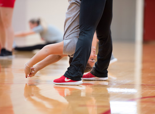 A bu dance member stretches