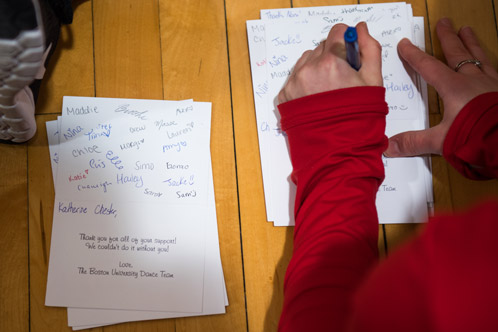 The dance team writes thank you notes to everyone who donated