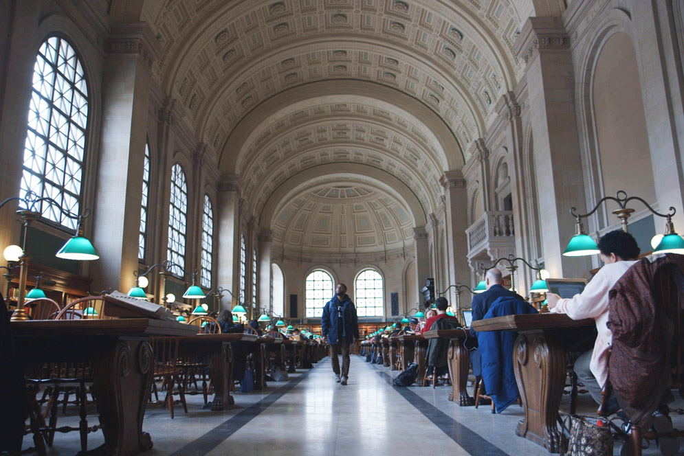 Charles Lewis walks through the Boston Public Library