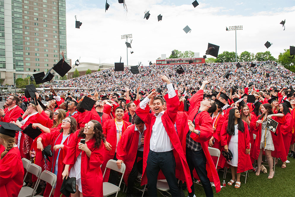 Graduates of the Class of 2018 throw their caps in the air at the end of Boston University's 145th All-University Commencement.