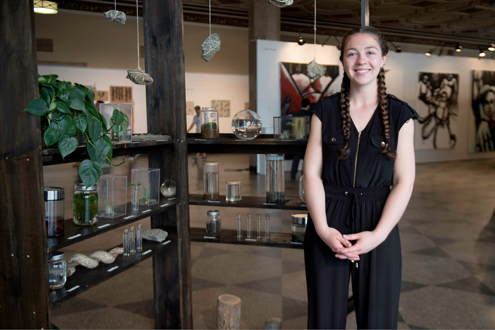 DeeDee Hughes with her untitled sculpture, made of wood and concrete.