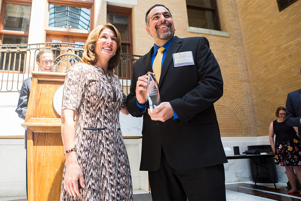 Jamil Siddiqui accepts his Teacher of the Year award at the Massachusetts State House.