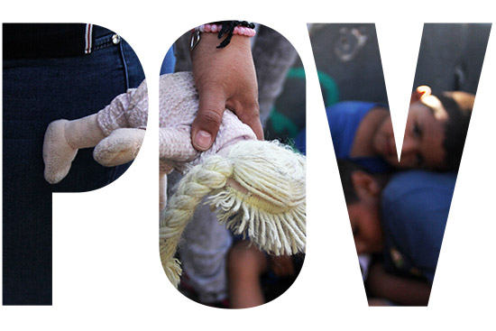 A Mexican woman holds a doll next to children at the Paso Del Norte Port of Entry, in the US-Mexico border in Chihuahua state, Mexico on June 20, 2018