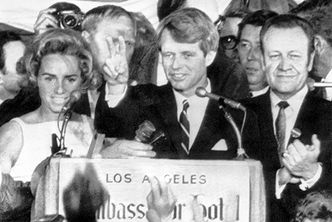 Robert F Kennedy holds two fingers up in a victory sign as he talks to campaign workers at the Ambassador Hotel in Los Angeles, prior to his assassination.