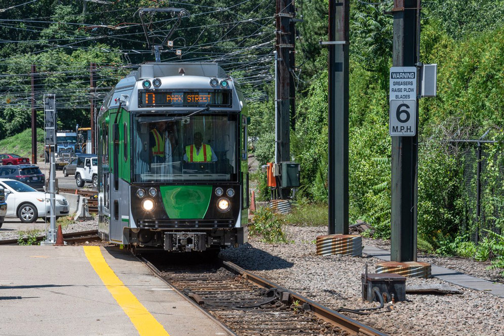 An MBTA green line car drives towards Park Street