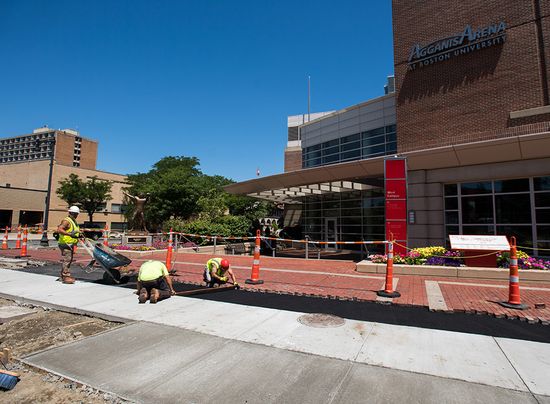 Workers build new sidewalks and protected bike lanes on Commonwealth Ave.