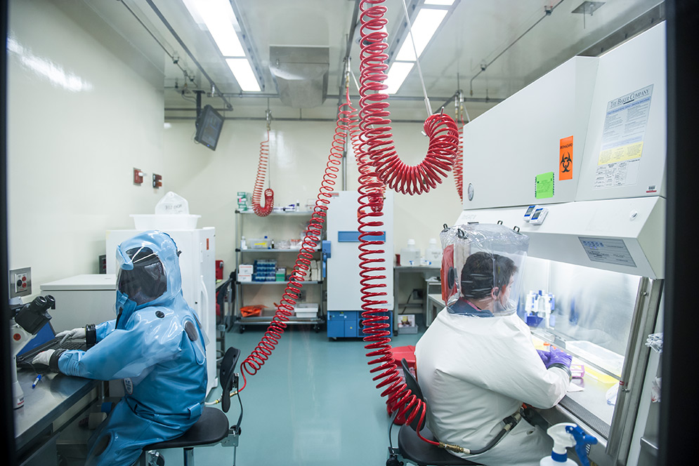 Infectious disease researchers Elke Mühlberger and Adam Hume conduct BSL-4 research at Boston University's National Emerging Infectious Diseases Laboratories (NEIDL).
