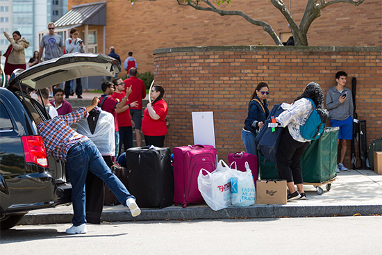 Parents and new students unload cars and trucks by the West Campus dorms of Boston University's Charles River Campus during Fall Semester move-in