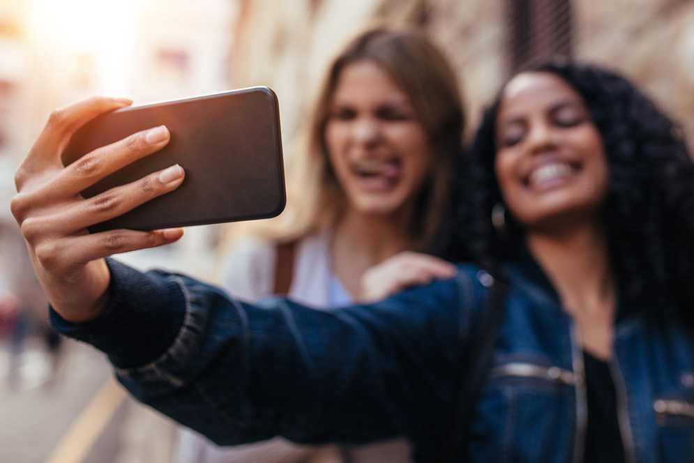 Two women take a selfie with an iphone