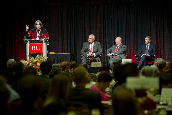 Distinguished Alumni Award recipient Sarah Degnan Kambou, Ph.D. speaks at the podium during the Best of BU Luncheon & University Alumni awards