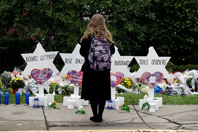 A person stands in front of Stars of David that are displayed in front of the Tree of Life Synagogue with the names of those killed in the deadly shooting in Pittsburgh, Pennsylvania.