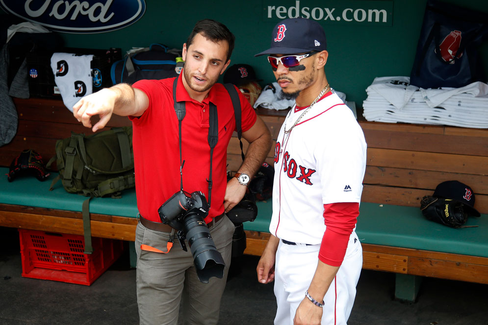 Weiss chats with Mookie Betts in the dugout before a game.