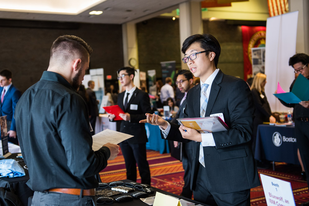 A student hands out a resume at an All-Majors Career Fair