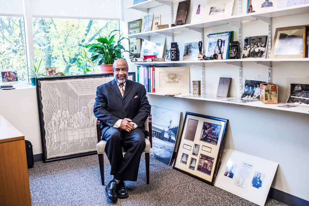 Leland Clarke sits in his office