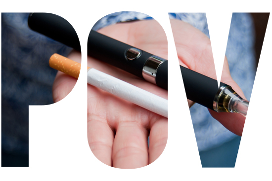 A woman's hand holding an e-cigarette vape pen and a traditional tobacco cigarette.