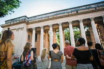 Boston University students look up at the pillared entrance of the University of Habana in the Vedado neighborhood of Havana, Cuba during a 2017 Alternative Spring Break visit.