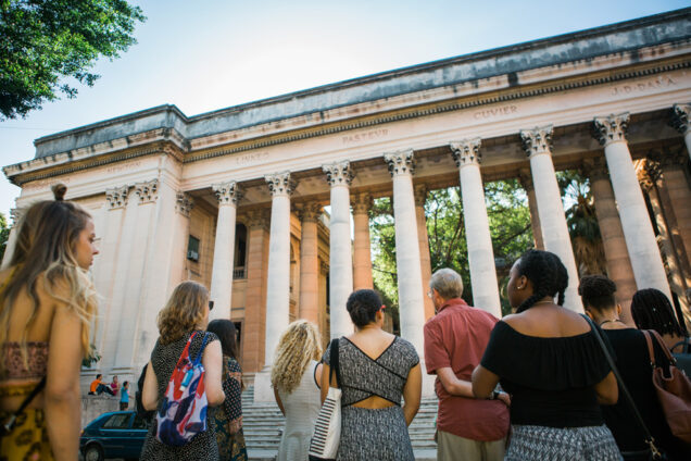 Boston University students look up at the pillared entrance of the University of Habana in the Vedado neighborhood of Havana, Cuba during a 2017 Alternative Spring Break visit.