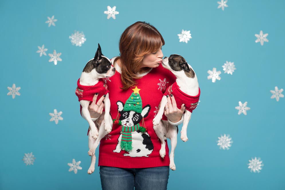 Nedra Abbruzzese-Werling poses in a Boston terrier–themed sweater alongside her two Boston terrier rescue dogs 