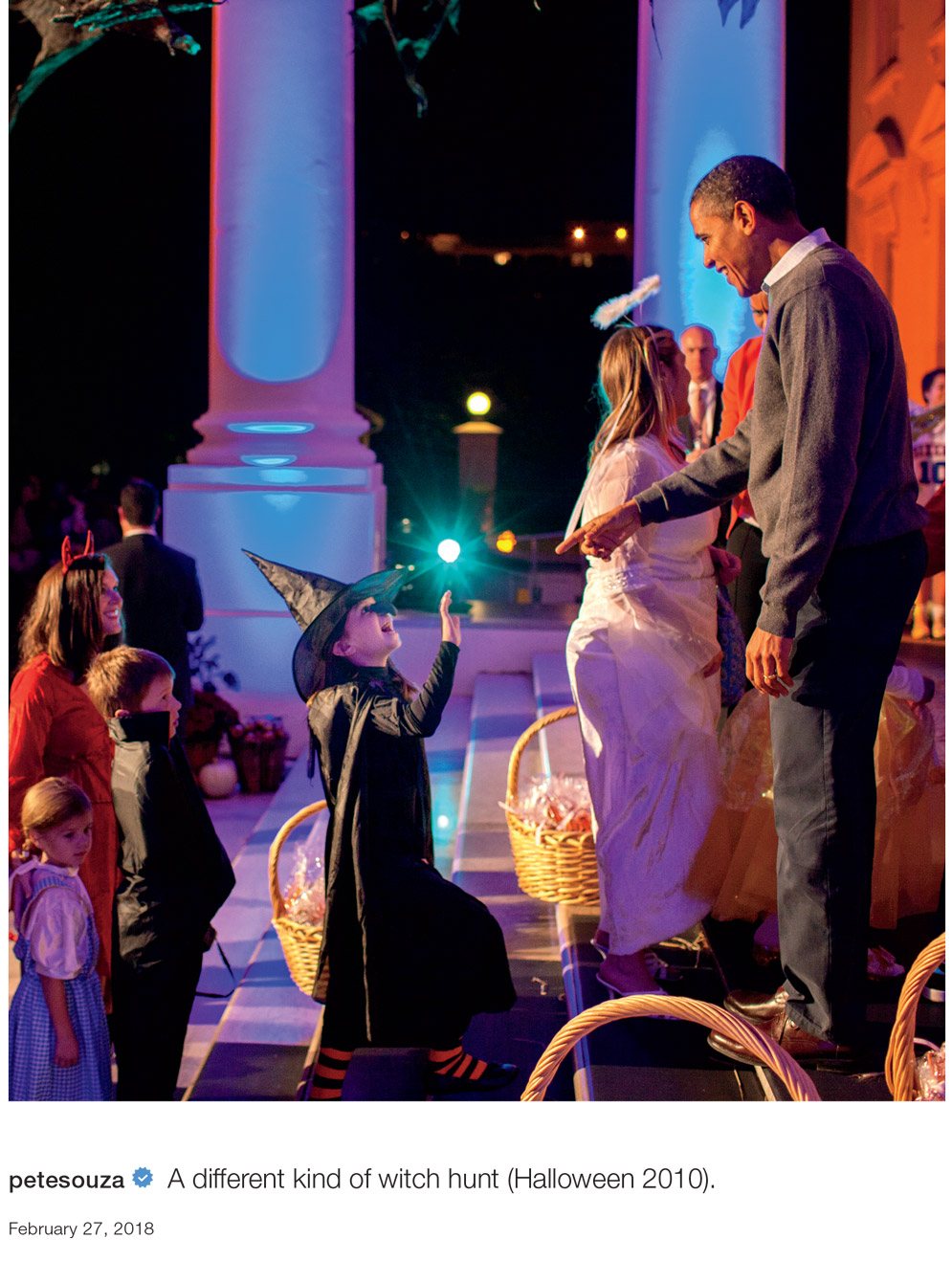 a photo of Obama greeting a little girl in a witch costume during trick-or-treating